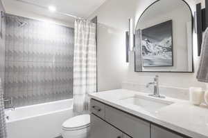 Full bath with shower / tub combo with curtain and vanity