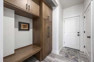 Mudroom with baseboards and light wood-style floors
