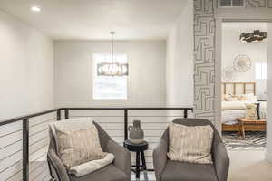 Living area with a chandelier, carpet floors, and recessed lighting