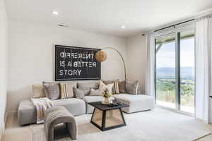 Carpeted living area featuring recessed lighting