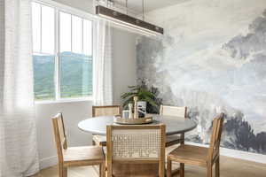Dining space featuring wood finished floors and baseboards