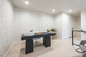 Office area with recessed lighting, carpet floors, wallpapered walls, and an accent wall