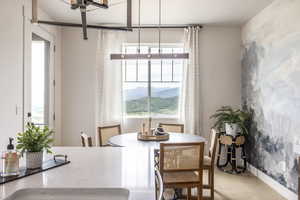 Dining area with a mountain view and wood finished floors