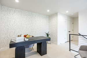 Carpeted office with recessed lighting and baseboards