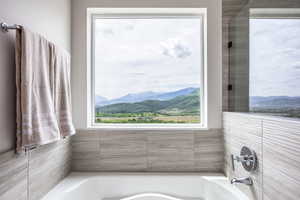 Bathroom with a mountain view and a garden tub