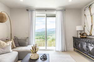 Carpeted living area featuring recessed lighting and a mountain view