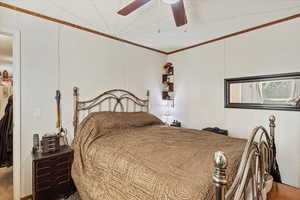 Bedroom featuring a ceiling fan and ornamental molding