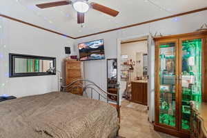 Bedroom with crown molding, ceiling fan, and vaulted ceiling