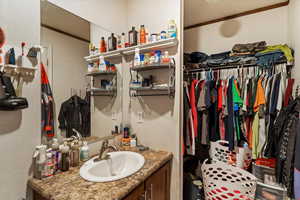 Bathroom with vanity and a textured wall