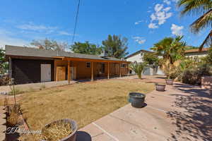 Back of property featuring brick siding and a shingled roof