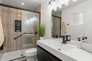 Full bath featuring vanity and a stall shower