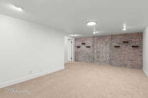 Finished below grade area featuring carpet floors and baseboards