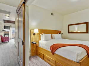 Bedroom featuring light colored carpet