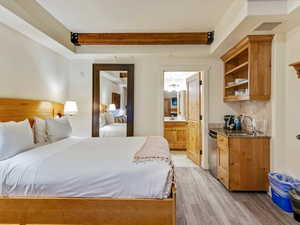 Bedroom featuring ensuite bathroom and a sink