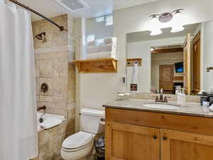 Full bath with vanity and tiled shower / bath combo