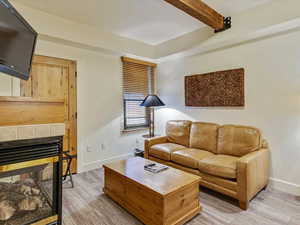 Living room with beam ceiling and a tiled fireplace