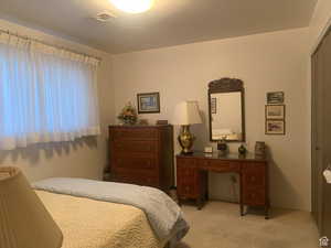 Bedroom featuring light carpet and a closet