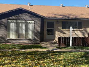 Property entrance featuring brick siding and roof with shingles
