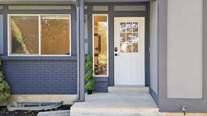 Doorway to property with brick siding