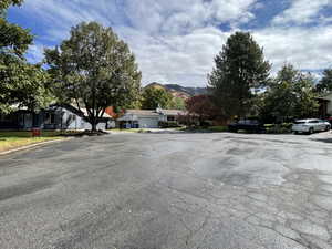 View of asphalt road featuring a residential view and a mountain view
