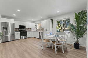 Dining space featuring light wood finished floors and recessed lighting