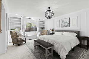 Bedroom with carpet, a chandelier, a textured ceiling, recessed lighting, and crown molding