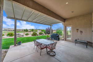 View of patio featuring a pergola, grilling area, and outdoor dining area