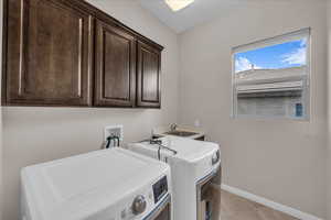 Laundry area featuring cabinet space and washing machine and dryer