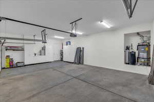 Garage with water heater and a garage door opener