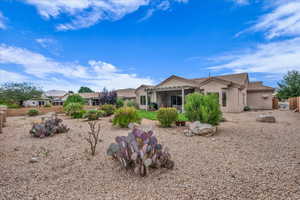 Rear view of property featuring stucco siding