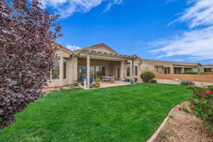 Rear view of house featuring stucco siding, a patio, and a pergola