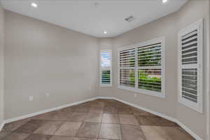 Unfurnished room with baseboards and recessed lighting