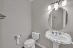 Bathroom with toilet and tile patterned flooring