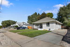 View of front of home with roof with shingles, a porch, and concrete driveway