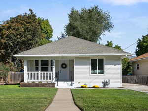 Bungalow-style house featuring covered porch and a shingled roof