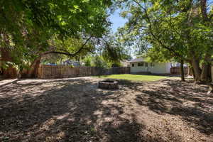 Fenced backyard with a fire pit