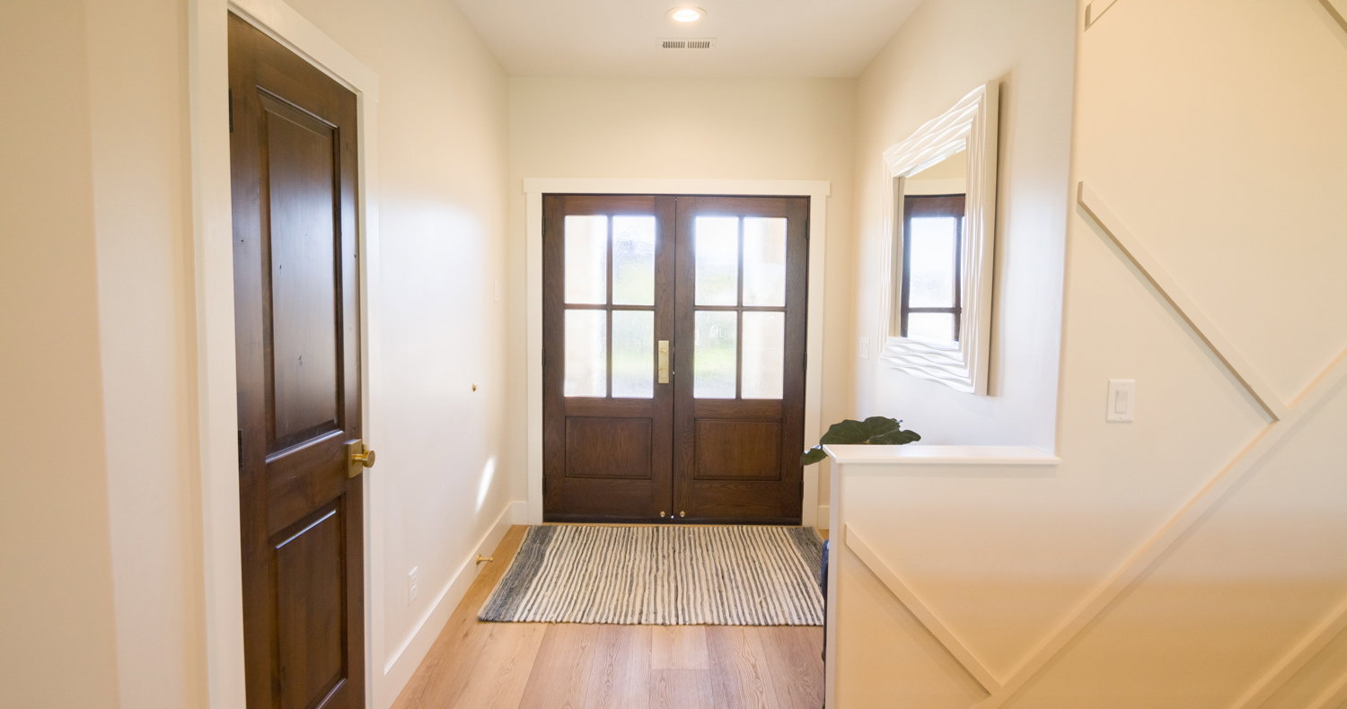 Doorway with wood finished floors and french doors