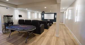 Home theater room featuring recessed lighting and light wood finished floors