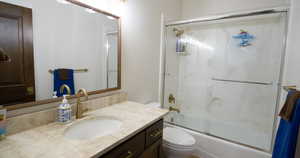 Bathroom with enclosed tub / shower combo and vanity
