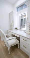Bathroom with light wood-type flooring and vanity