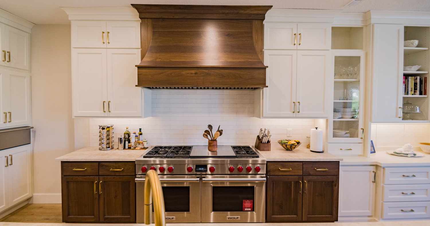 Kitchen with white cabinetry, range with two ovens, tasteful backsplash, and custom range hood