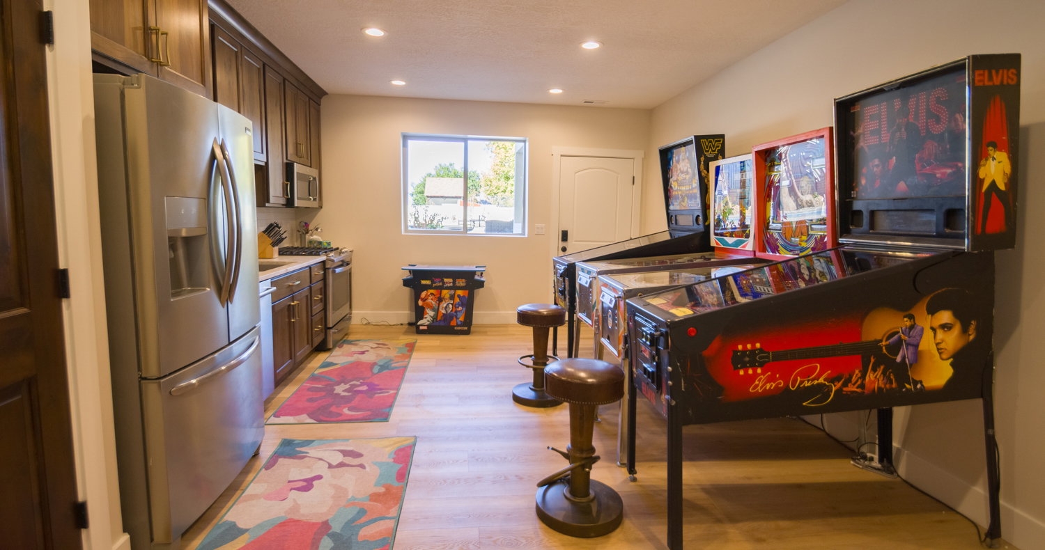 Kitchen with appliances with stainless steel finishes, light wood-style flooring, light countertops, recessed lighting, and dark brown cabinetry