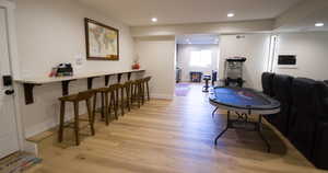 Dining space with light wood-style floors and recessed lighting