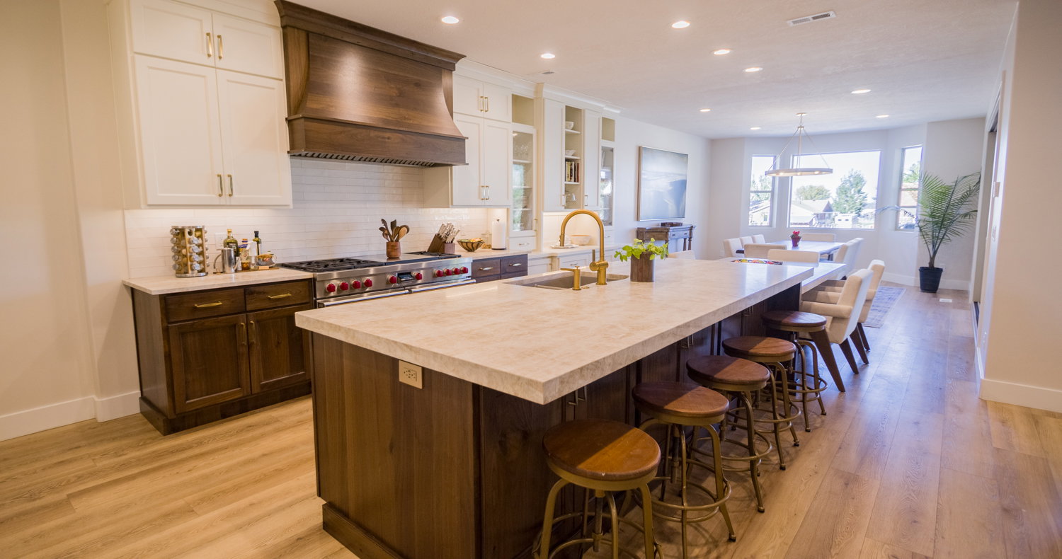Kitchen featuring backsplash, a kitchen breakfast bar, glass insert cabinets, custom range hood, and white cabinets