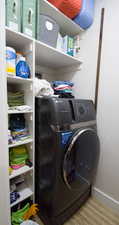 Laundry area featuring washer / clothes dryer and baseboards