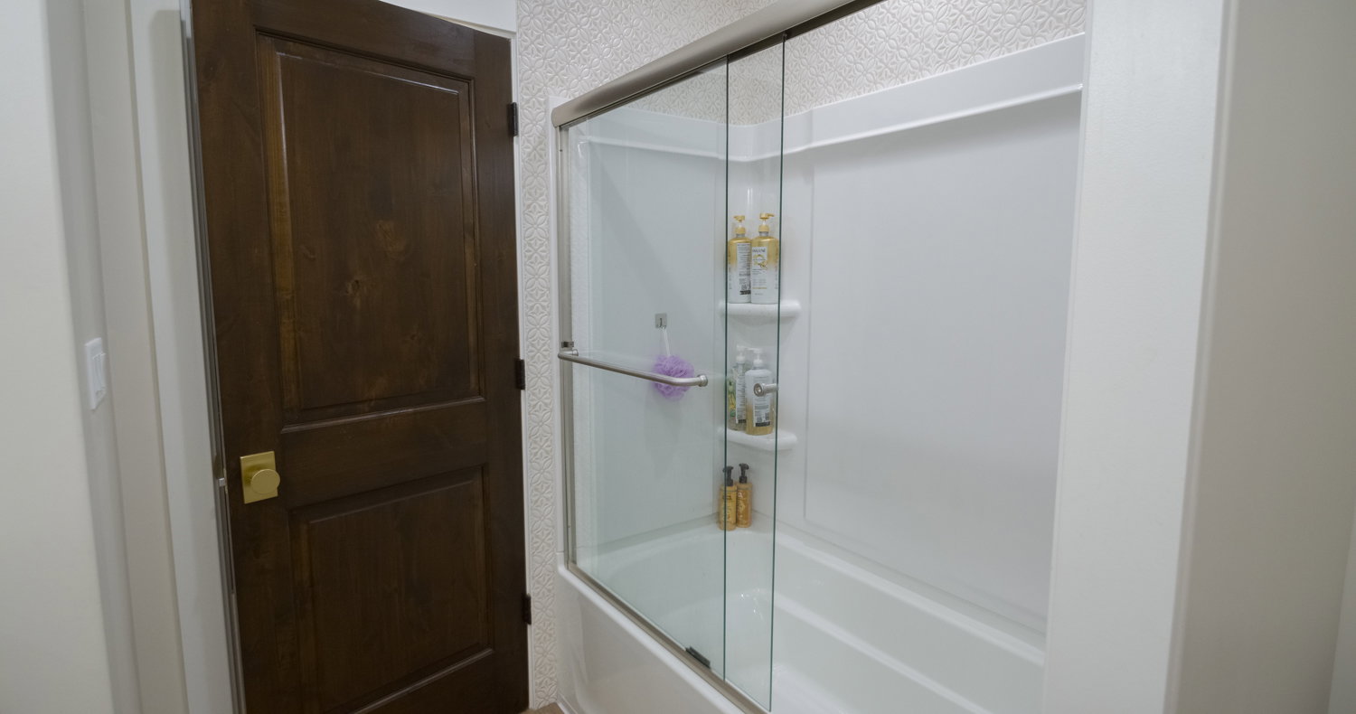 Bathroom with enclosed tub / shower combo