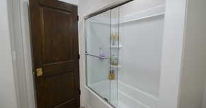 Bathroom with enclosed tub / shower combo