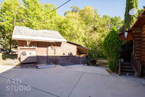 View of home's exterior featuring log siding and an outbuilding