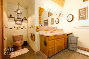 Half bath featuring vanity and backsplash