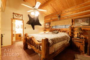 Carpeted bedroom featuring rustic walls, a ceiling fan, and a wood ceiling with exposed beams